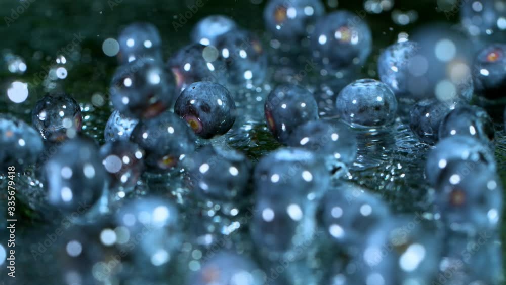 Super Slow Motion Shot of Fresh Blueberries Falling into Water and Splashing at 1000fps. Super Slow Motion Shot of Fresh Blueberries Falling into Water and Splashing at 1000fps.
