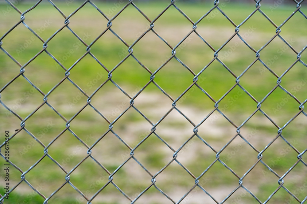 Fence Pattern with Field and Grass in the Background Fence Pattern with Field and Grass in the Background