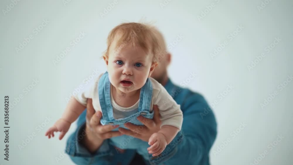 father holds a child and plays with him. father holds a child and plays with him.