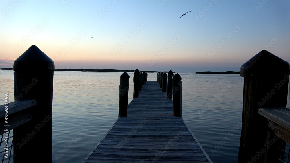 Beautiful pier in the evening at a calm sea Beautiful pier in the evening at a calm sea