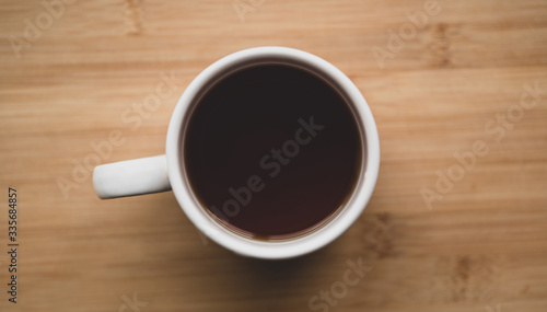 top view of cup of tea on a wooden table.