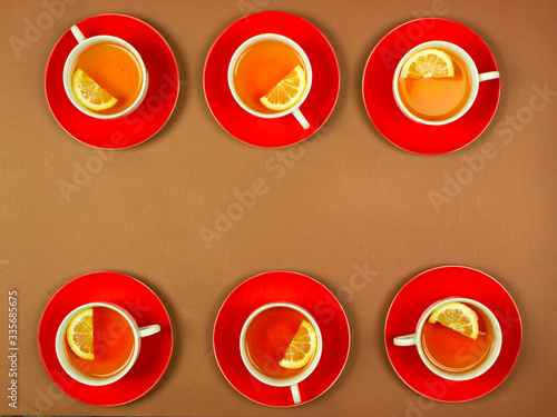 many cups stand in a row, tea with lemon, dishes, a warming drink for health, top view