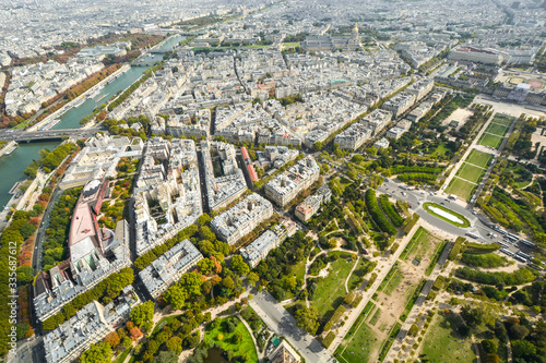 Overhead view from the Eiffel Tower platform of the city of Paris France with the Seine river, Champ de Mars park and Ecole Militaire in view.