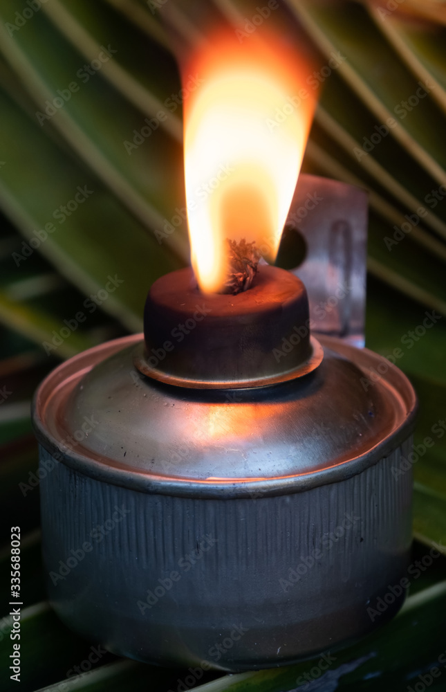 Traditional Malay oil lamps on coconut leaves. Traditional Malay oil lamps on coconut leaves.