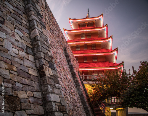 The Reading Pagoda shot from below featuring a massive stone wall at its base photo