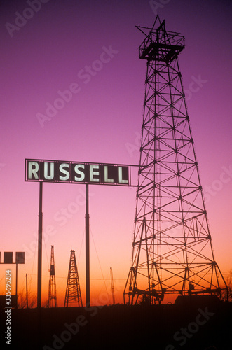 Fotografia Obsolete oil rigs at sunset, Russell, KS