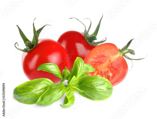 Fresh basil leaves and organic tomatoes isolated on white