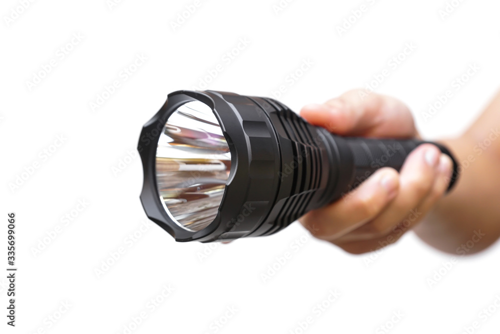 Hand holding a big LED torch isolated / Flashlight for camping Hand holding a big LED torch isolated / Flashlight for camping