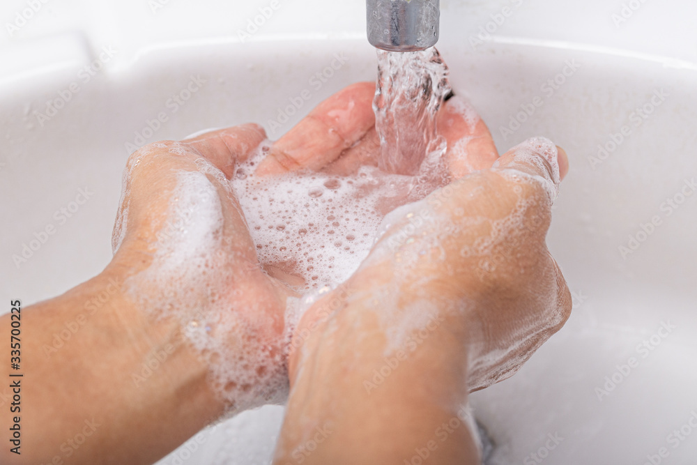 Fototapeta premium Washing thoroughly your hands with water and soap