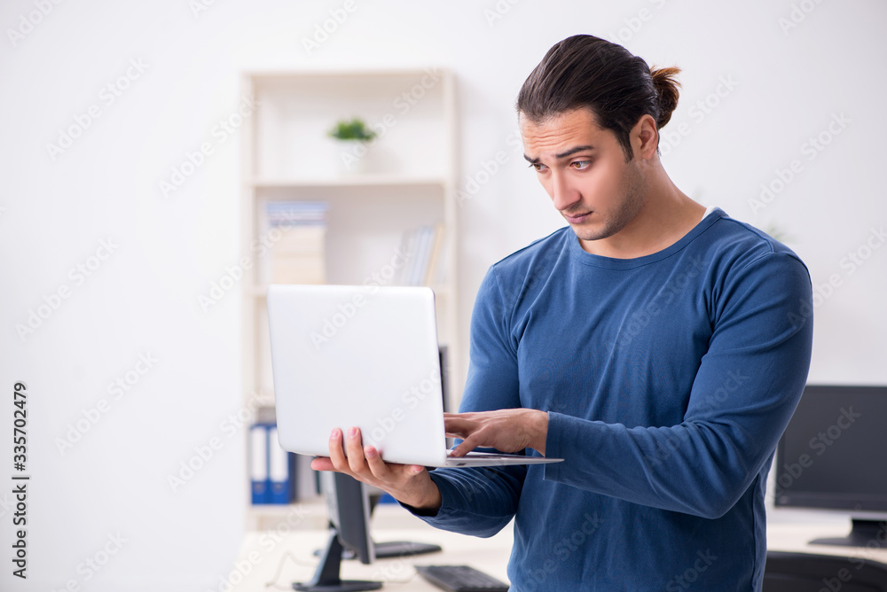 Young male it specialist working in the office Young male it specialist working in the office