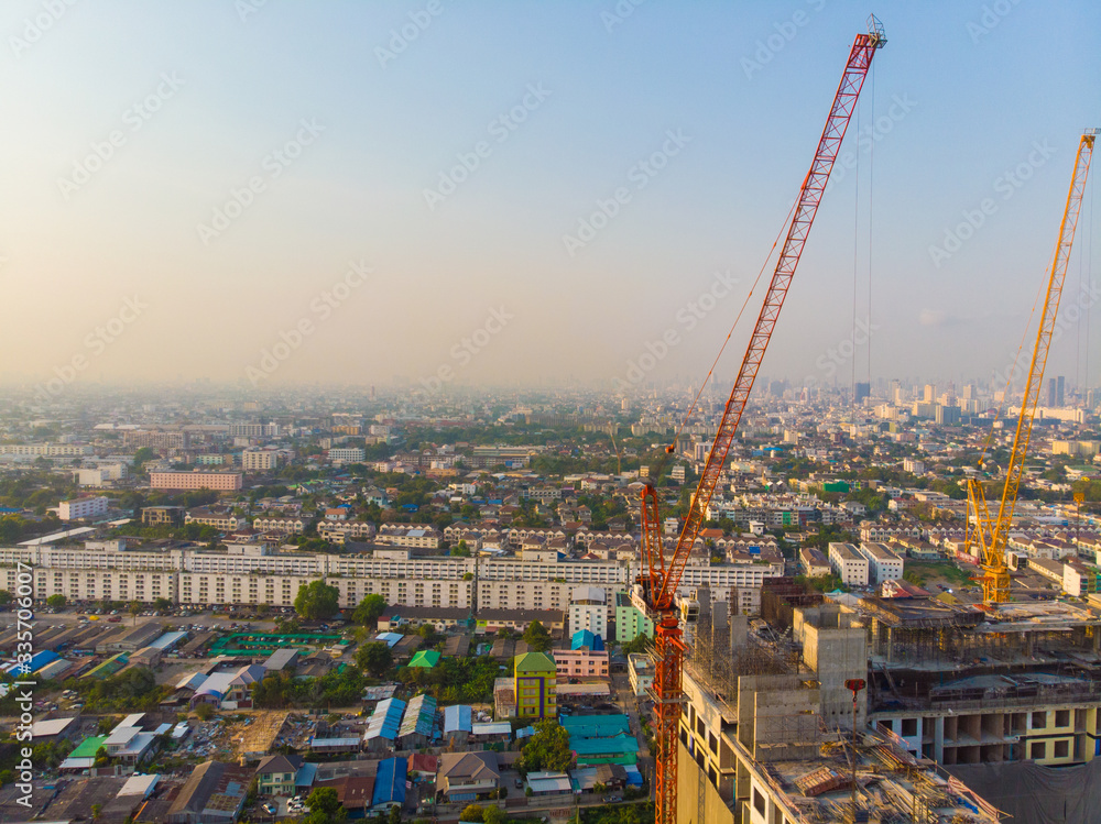 Construction site building with crane high rise condominium sunset light
