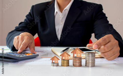 Close-ups of coin-holding business women, including house-on-coin models, ideas for saving money and real estate investment.