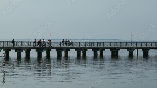 Wallpaper Mural People walking on a pier inside the sea with Russia flag waving in wind Torontodigital.ca