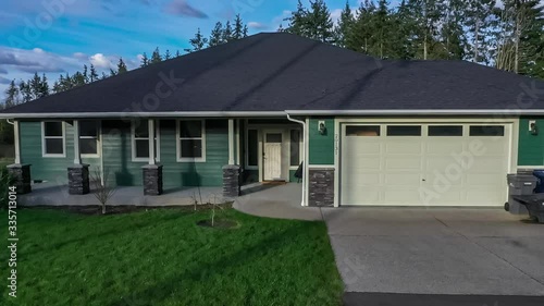 Aerial footage of a modern suburban home, zooming in to the front door, starting with a tiny planet effect