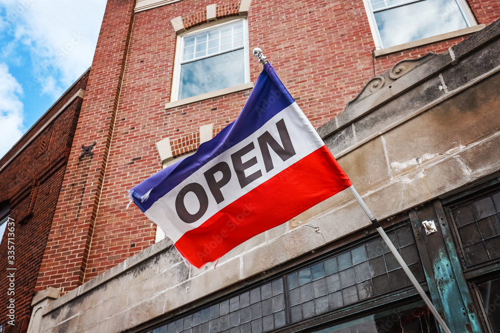 Obraz premium Red white and blue flag Open sign on a business