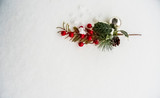 Colorful Christmas decorations isolated against real snow shot top down. 