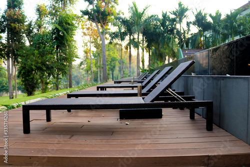 Sun beds by the pool in the open air with nature. Pool at the spa resort.