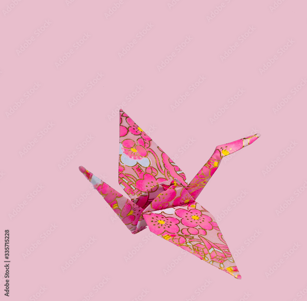 Japanese origami storks on colorful background.