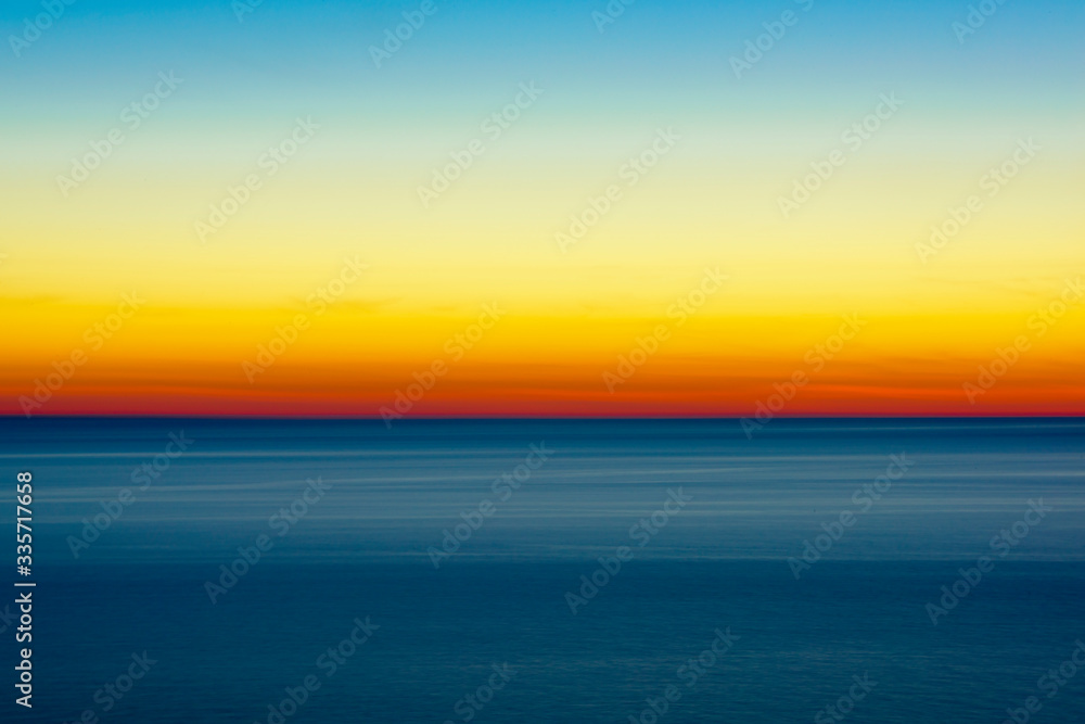 Fototapeta premium Artistic shot of sunset shot with long exposure and intentional movement photo technique. 