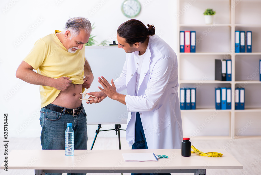 Fototapeta premium Doctor dietician giving advices to fat overweight patient