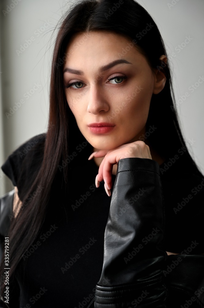 Vertical portrait of a brunette girl on a white background Vertical portrait of a brunette girl on a white background