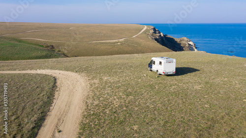 A motor home by the sea. Aerial photography. From a bird's-eye view. A house on wheels. Self-isolation. Life in nature. Camper. RV