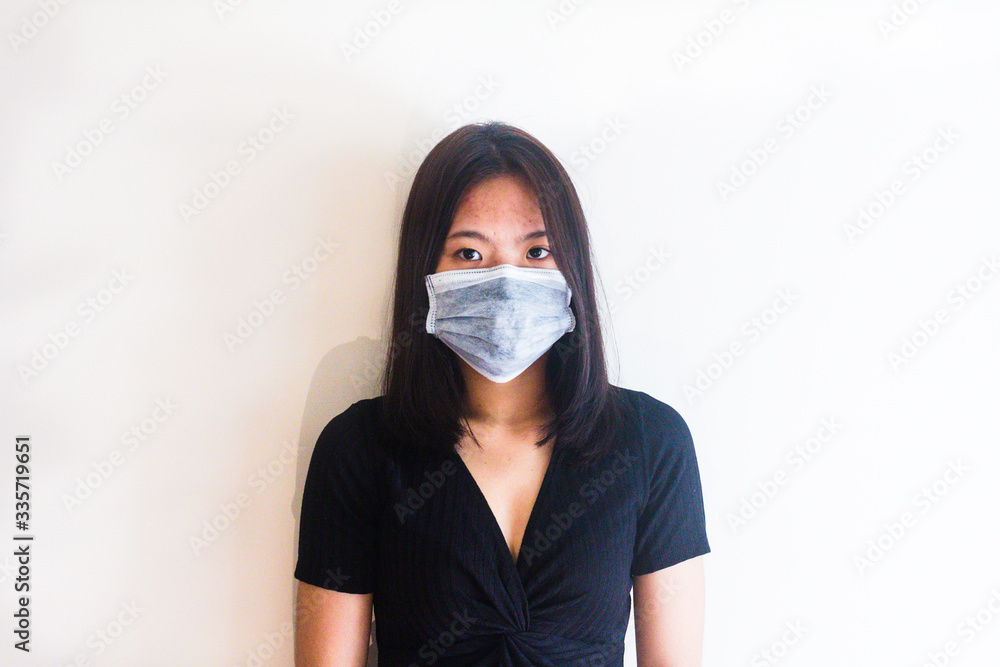 Asian young girl is wearing medical face masks to protect from Coronavirus Asian young girl is wearing medical face masks to protect from Coronavirus