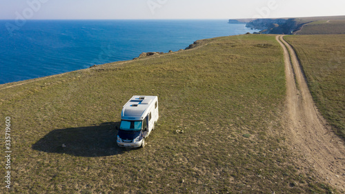A motor home by the sea. Aerial photography. From a bird's-eye view. A house on wheels. Self-isolation. Life in nature. Camper. RV