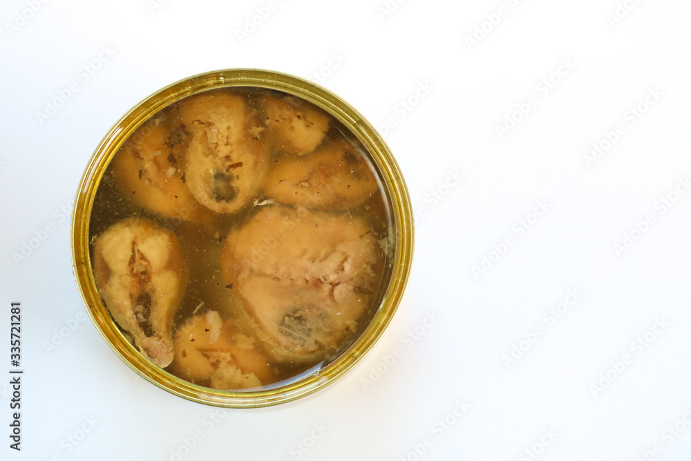 Open can of preserved fish on white background. Top view, copy space Open can of preserved fish on white background. Top view, copy space