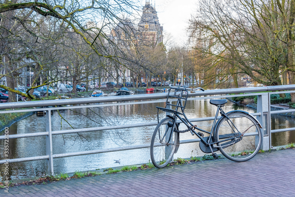 A typical Dutch scene with bicycle on a bridge in Amsterdam. A typical Dutch scene with bicycle on a bridge in Amsterdam.