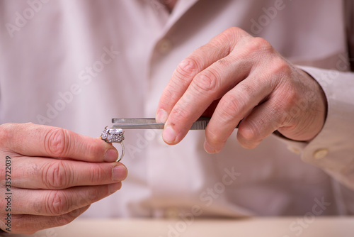 Old male jeweler at workshop