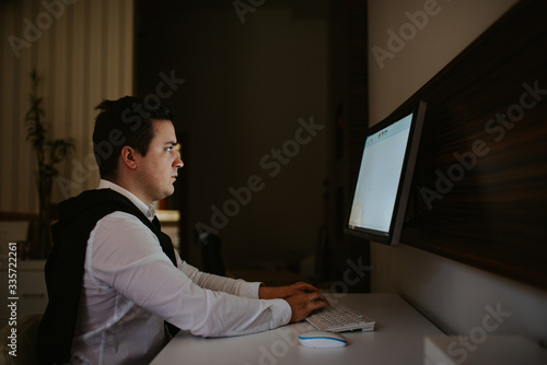  Young caucasian businessman in the office working on computer. Businessman, work and technology