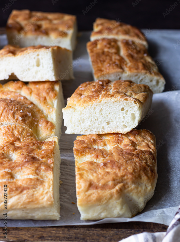 Traditional Italian focaccia bread with salt and olive oil. Homemade flat bread focaccia. Focaccia Genovese. Traditional Italian focaccia bread with salt and olive oil. Homemade flat bread focaccia. Focaccia Genovese.