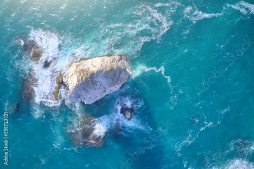 Photography Aerial view of waves and sea rocks.