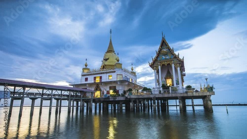 Time lapse of thai temple building located on the sea at sunrise timing under clody sky location at chachoengsao province of thailand photo