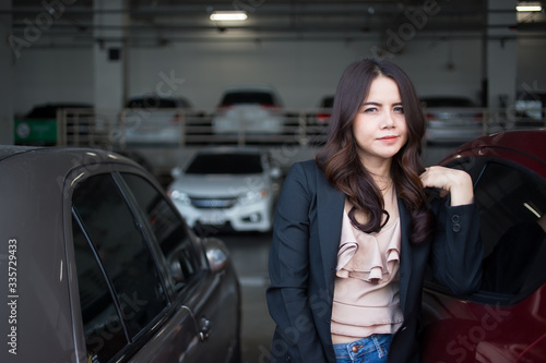 Beautiful Asia business woman over blured parking background.