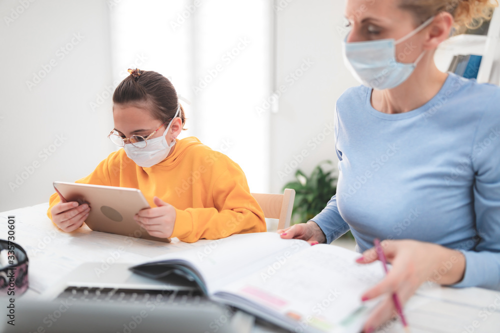 Child home studying education, homeschooling, with private tutor / mother with protective mask in the time of viruses, flu and seasonal pandemic, healthy approach in social contact. Child home studying education, homeschooling, with private tutor / mother with protective mask in the time of viruses, flu and seasonal pandemic, healthy approach in social contact.