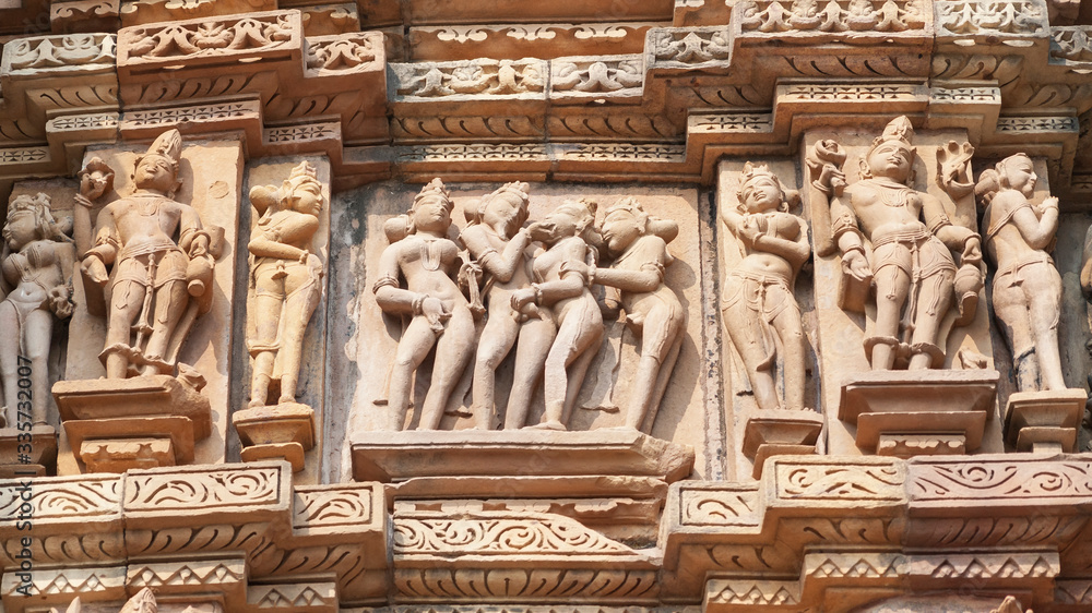 Stone carved erotic bas-relief Sculpture of love making in Kandariya Mahadeva Temple, Khajuraho Group of Monuments, India