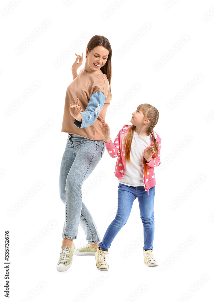 Happy mother and her little daughter dancing against white background Happy mother and her little daughter dancing against white background