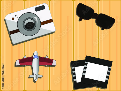Top view of the set objects for travelling on wooden background. Flat lay.
