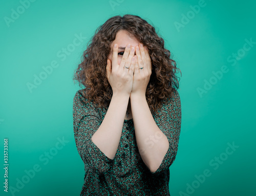  Woman covers his face by hand photo