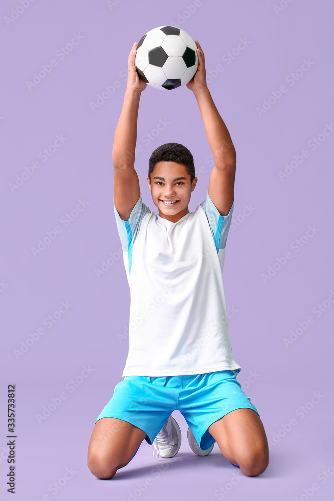 Happy African-American football player on color background Happy African-American football player on color background