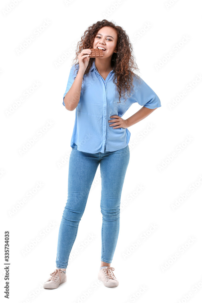 Young African-American woman with chocolate on white background Young African-American woman with chocolate on white background