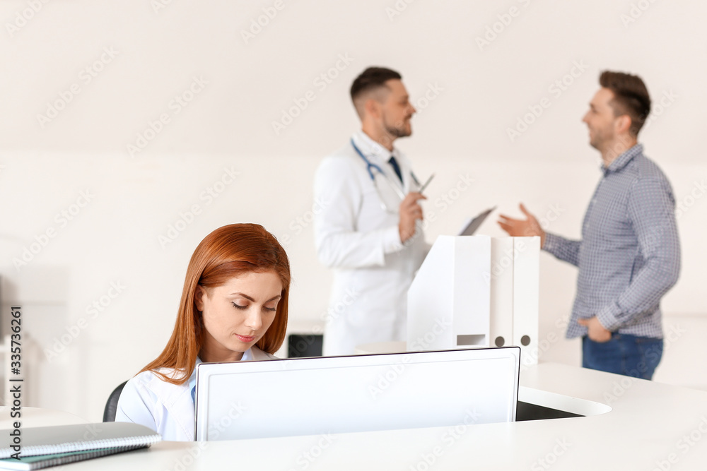 Female medical assistant working in clinic Female medical assistant working in clinic