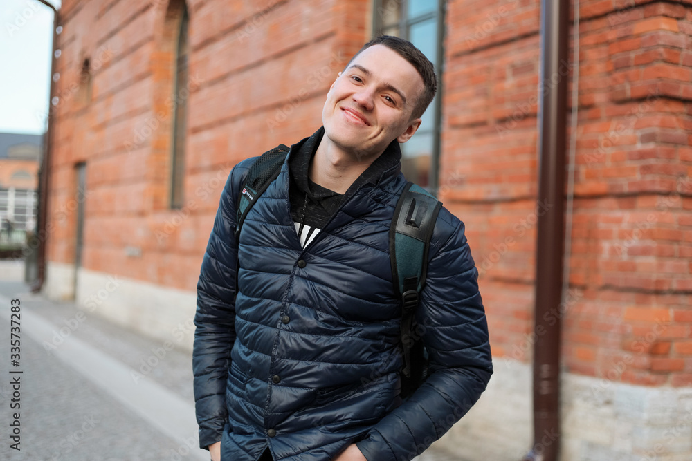 Obraz premium Handsome young fashion model posing on city streets. Lifestyle c