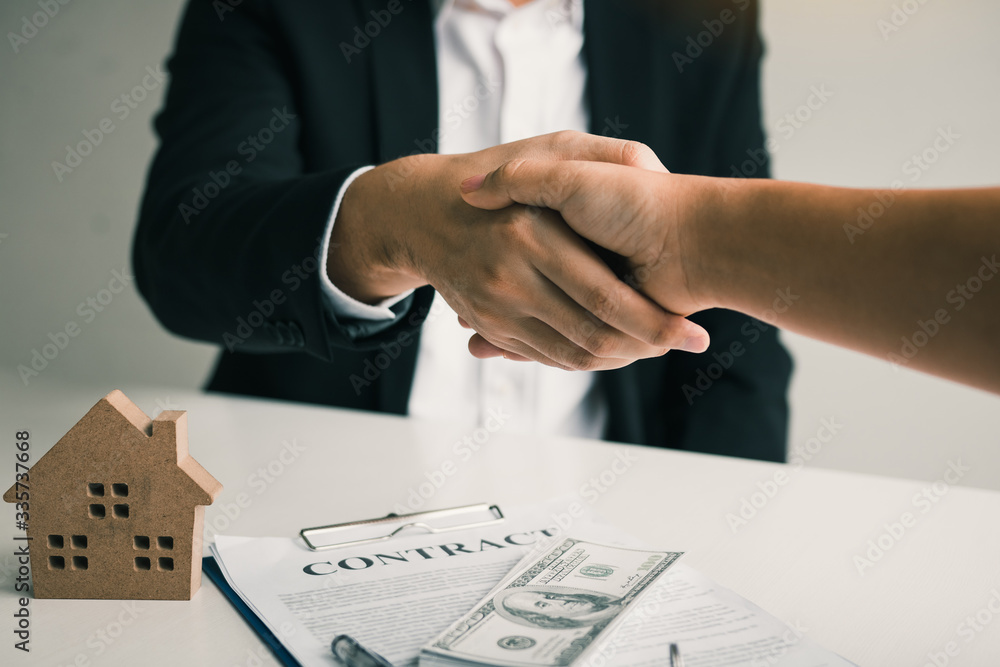 Obraz premium Home sales agents and buyers work on signing new homes and shaking hands.