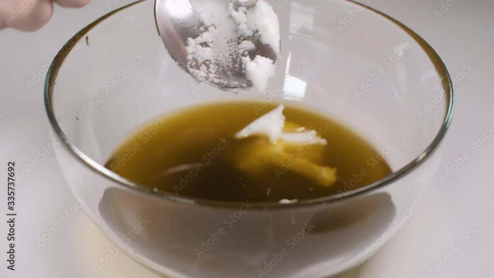 Close up of home made ointment creating process. Adding thick coconut oil into herbal oil base. 4K resolution Close up of home made ointment creating process. Adding thick coconut oil into herbal oil base. 4K resolution