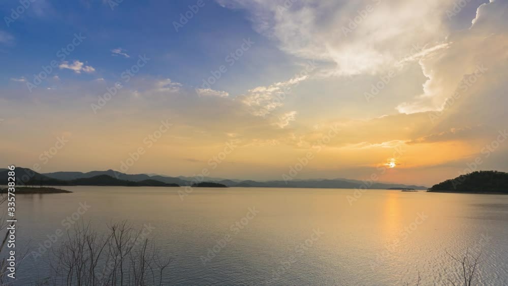 Time laps of small island in dam under cloudy sky at sunset time location at south of thailand Time laps of small island in dam under cloudy sky at sunset time location at south of thailand