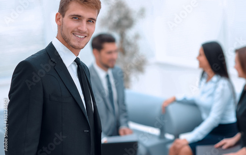 portrait of confident businessman on background of office.