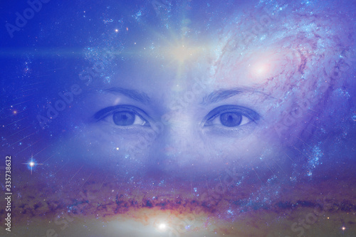 the eyes of a clairvoyant in space against the background of the starry sky and galaxies. The concept of clairvoyance, esotericism or astrology. Elements of this image furnished by NASA photo